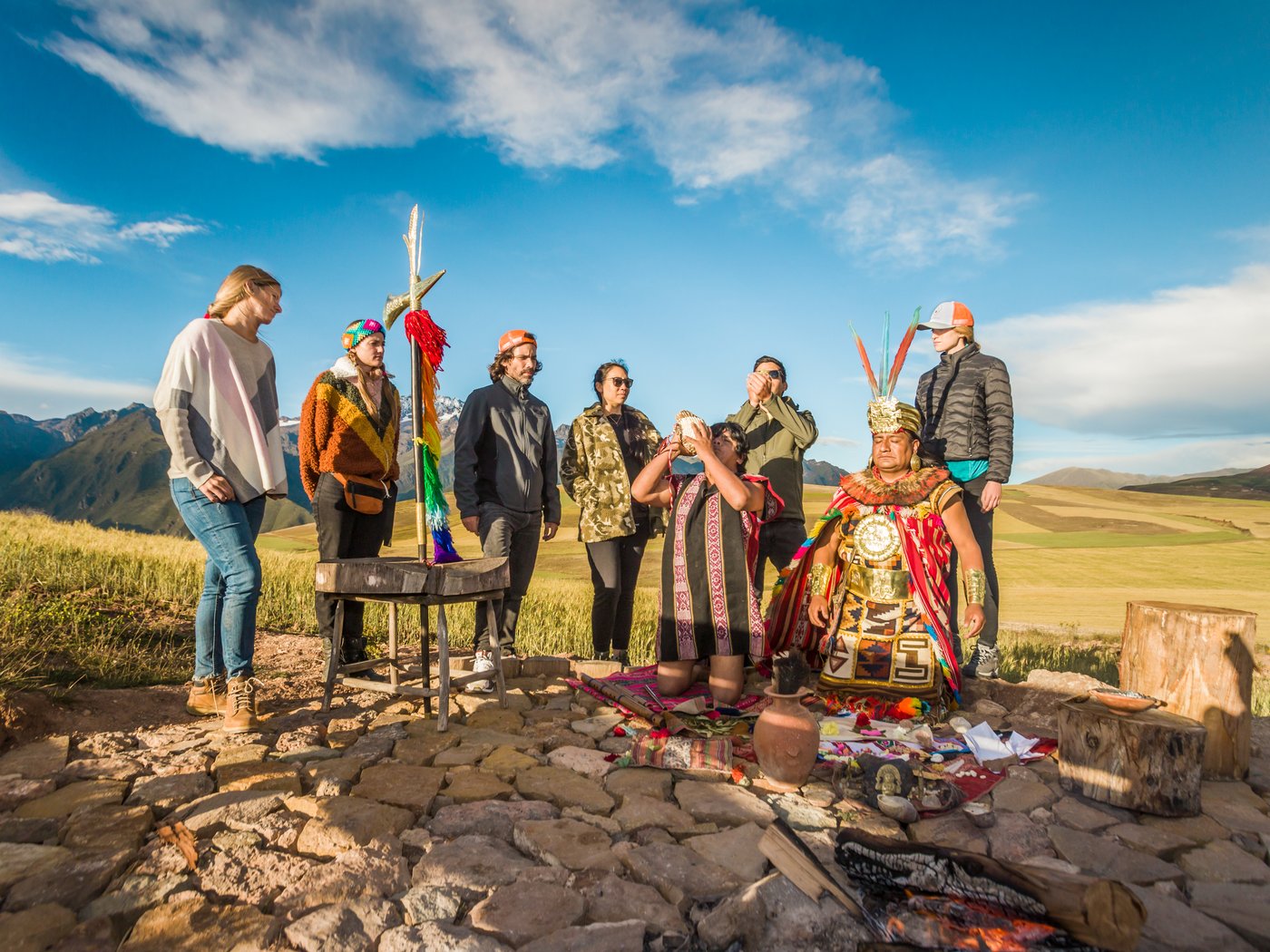 Guests gather around an Andean offering ceremony above the Sacred Valley